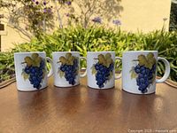 Four BIA Cordon Bleu grape mugs on tabletop