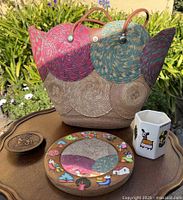Group shot showing woven tote, wooden mirror, carved coaster, ceramic holder