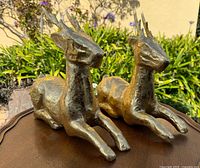 Front view of both gold reindeer figurines on tabletop