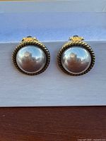 Front view of both dome sterling earrings with rope borders