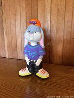 Front view of Bugs Bunny figurine showcasing jersey text and sneakers