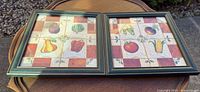 Both framed vegetable tile artworks side by side