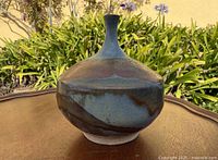 Front view of stoneware vase showing bulbous body and narrow neck