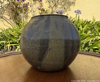 Front view of round stoneware vase showing glaze coloration