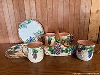 Full set showing handled basket, three mugs, oval tray, two round plates