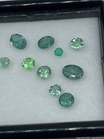 Front view showing all 11 Alexandrite stones in display case