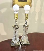 Both lead crystal lamps side by side showing full design, bases, sockets and bulbs