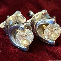 Close-up of both earrings showing diamond stones and white gold setting