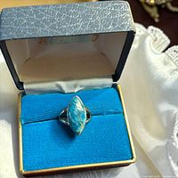 Ring in open presentation box, top view of stone and setting