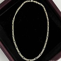 Entire Figaro chain laid in oval displaying full length and link pattern