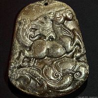 front view showing carved horse design and hole