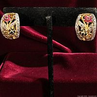 Front view of both gold over sterling silver gemstone earrings on stand