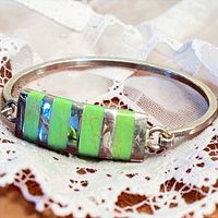 Full view of bracelet on lace showing inlay detail