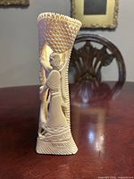 Front view showing relief figures and lattice top