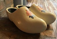Oblique view of both clogs showing rose artwork and overall color