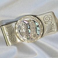 Front view showing engraved scrollwork and abalone inlay Aztec motif
