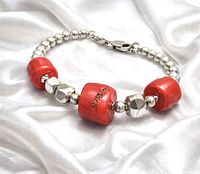 Full view of bracelet showing coral beads, silver beads and clasp