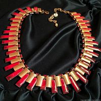 Front view of necklace showing alternating red enamel and polished copper panels