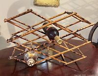 Wine rack partially open holding two bottles to show capacity