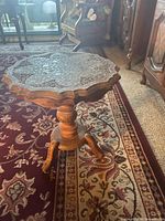 Top view of scalloped teak table showing brass inlay pattern
