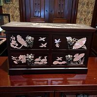 front view showing four drawers, inlay and hardware