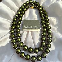 Necklace laid out showing full strand and Classics Collection card