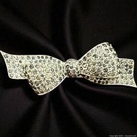 Front view showing crystal-covered bow brooch