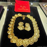 Necklace, earrings and red KJL pouch overview