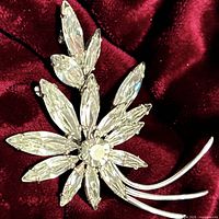 Front view of crystal floral brooch on velvet background