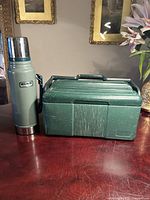 Stanley thermos standing beside closed lunch box