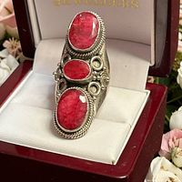 Front view showing three cabochon rubies and design details