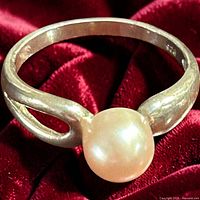 Top view of sterling silver ring with pearl