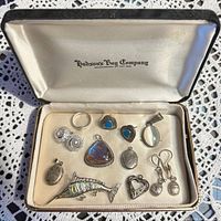 Assorted sterling silver items arranged in Hudson’s Bay Company case