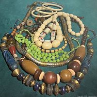 Group view of all jewelry on teal background