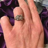 Ring worn on hand showing setting detail and size