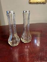Pair of clear glass bud vases with sterling rims