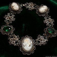 Front view showing alternating cameo and green glass settings