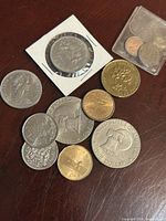 Group view showing all coins including holder and plastic sleeve
