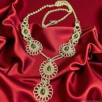 Front view of necklace on red fabric