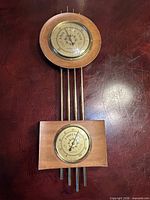 Full view of wood and brass weather station showing both dials and connecting rods