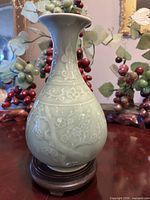 Front view of green celadon porcelain vase on stand