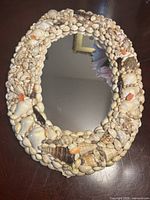 Front view of oval shell mirror