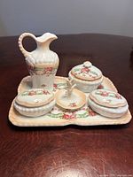 Full view of five-piece porcelain vanity set on tray