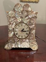 Front view of lucite seashell mantel clock