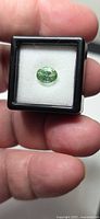 Front view of oval mint tourmaline in display box
