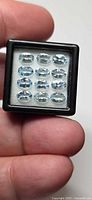 12 aquamarine gemstones in display case