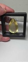 Pear cut yellow citrine in floating case, frontal view