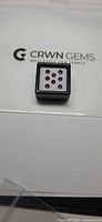 Eight loose rubies in CRWN Gems display box