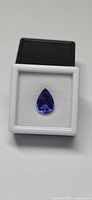 Pear-cut tanzanite in display box front view