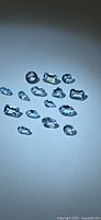 Group of light blue aquamarine gemstones on neutral background